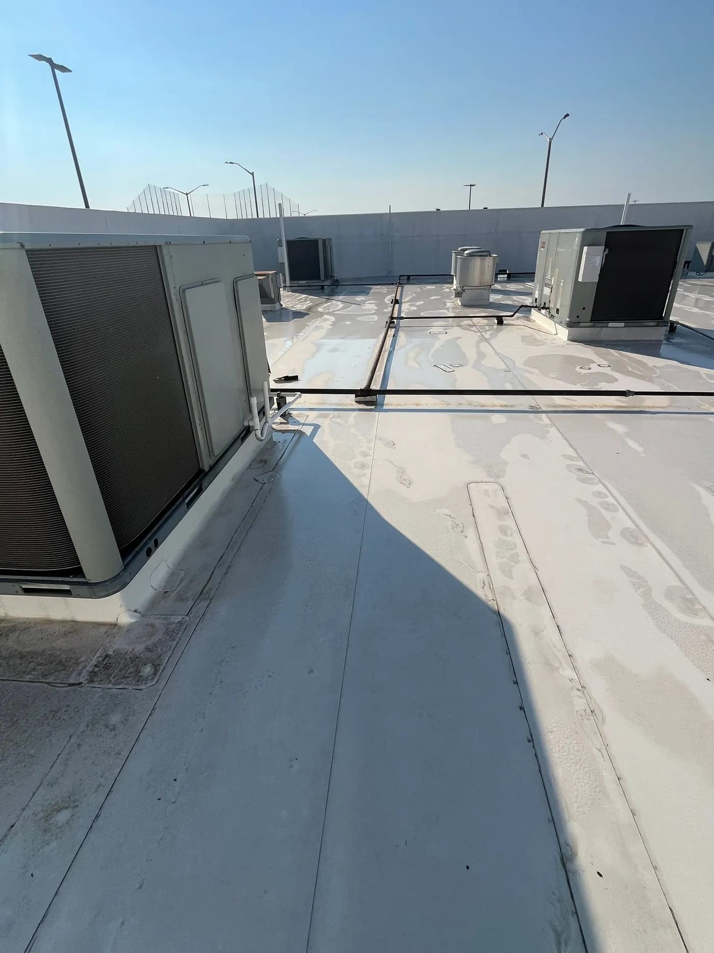 Same Little Rock commercial flat roof after soft-wash, with clean white membrane and restored reflectivity
