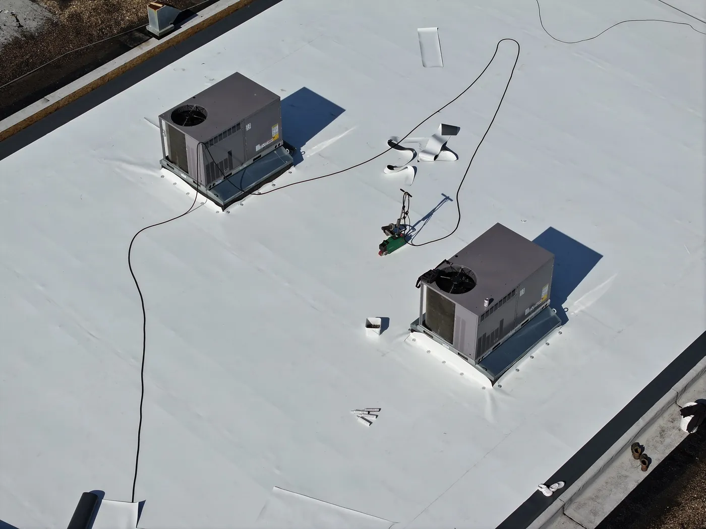 Drone aerial of a finished white TPO commercial roof with HVAC rooftop units