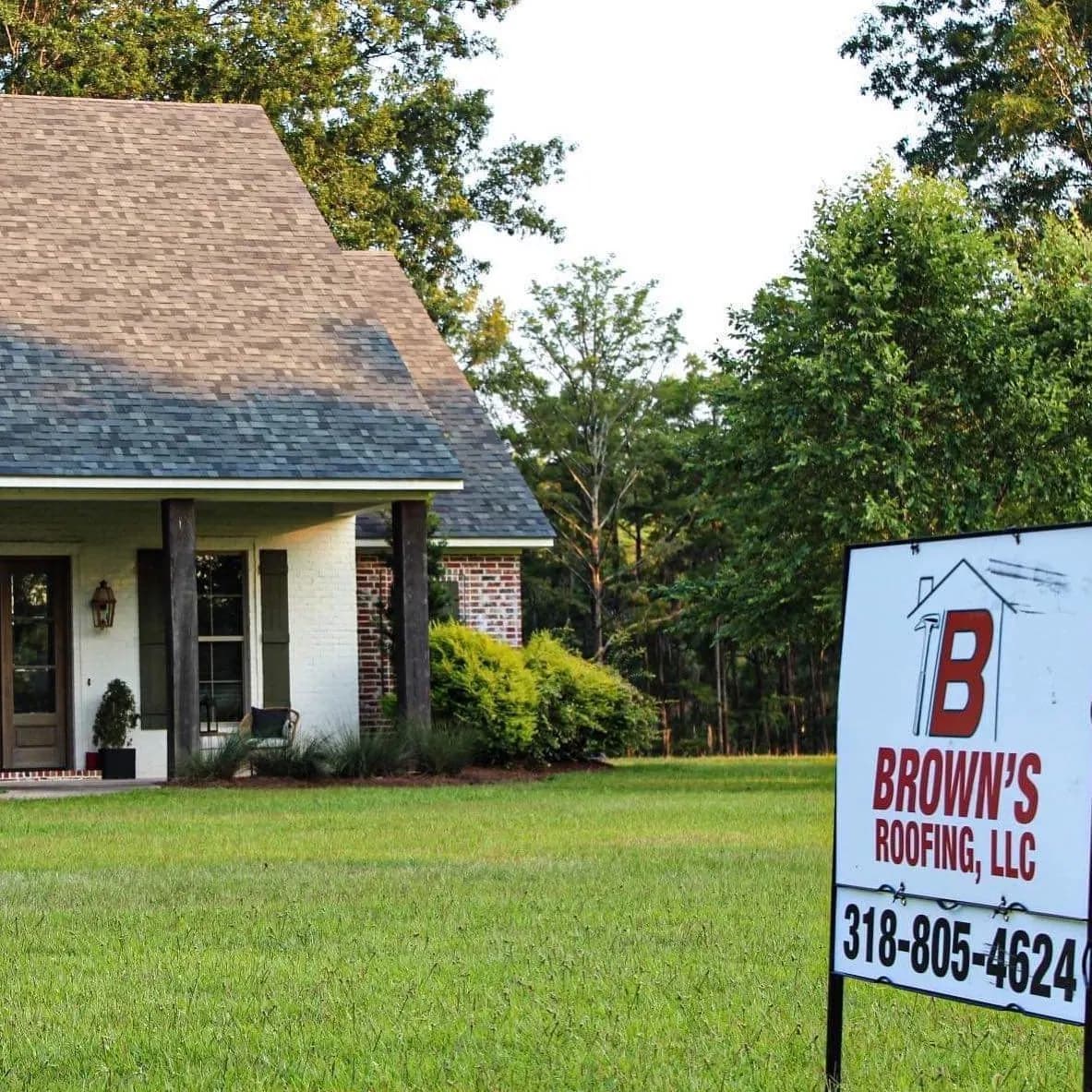 Brown's Roofing branded yard sign in front of a finished residential roof