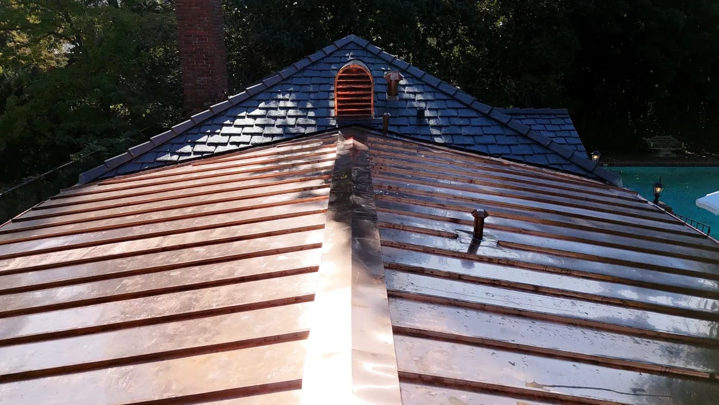 Copper standing-seam metal roof installation with concealed fasteners