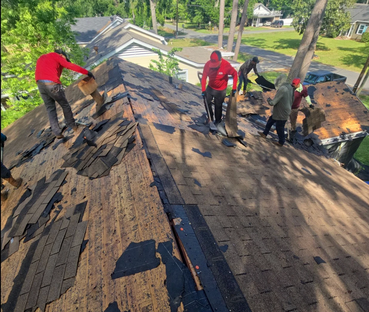 Multi-layer shingle tear-off down to the deck during a roof replacement in the Lafayette area