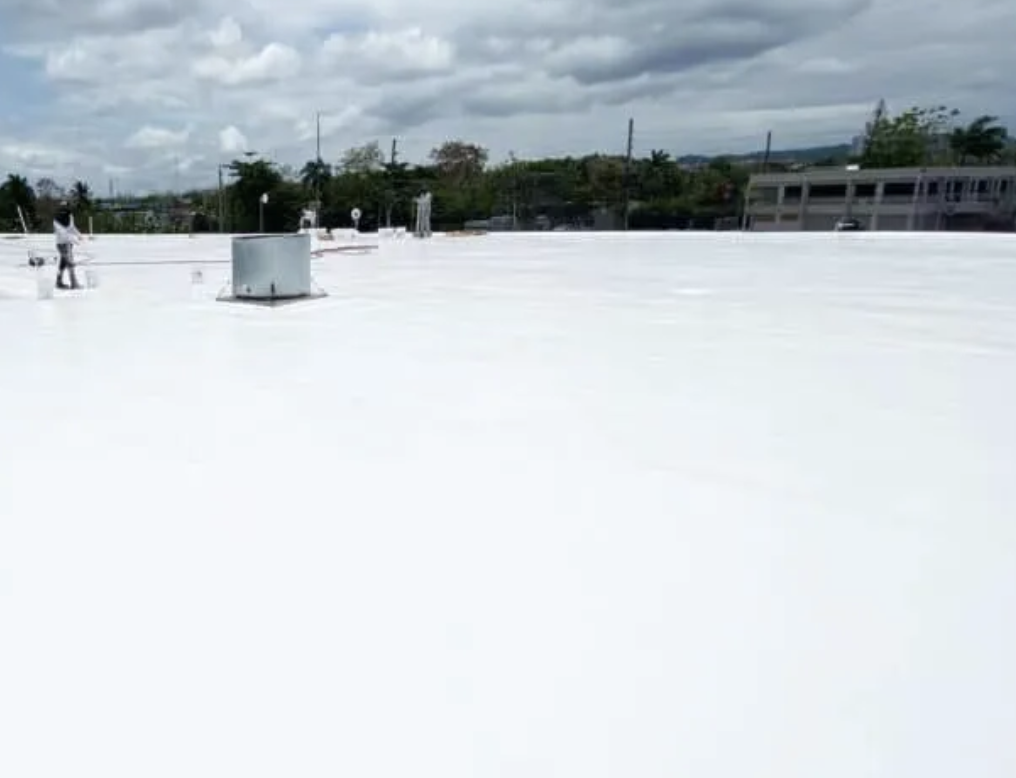 Reflective roof coating restoration applied to an aging low-slope commercial roof in Louisiana