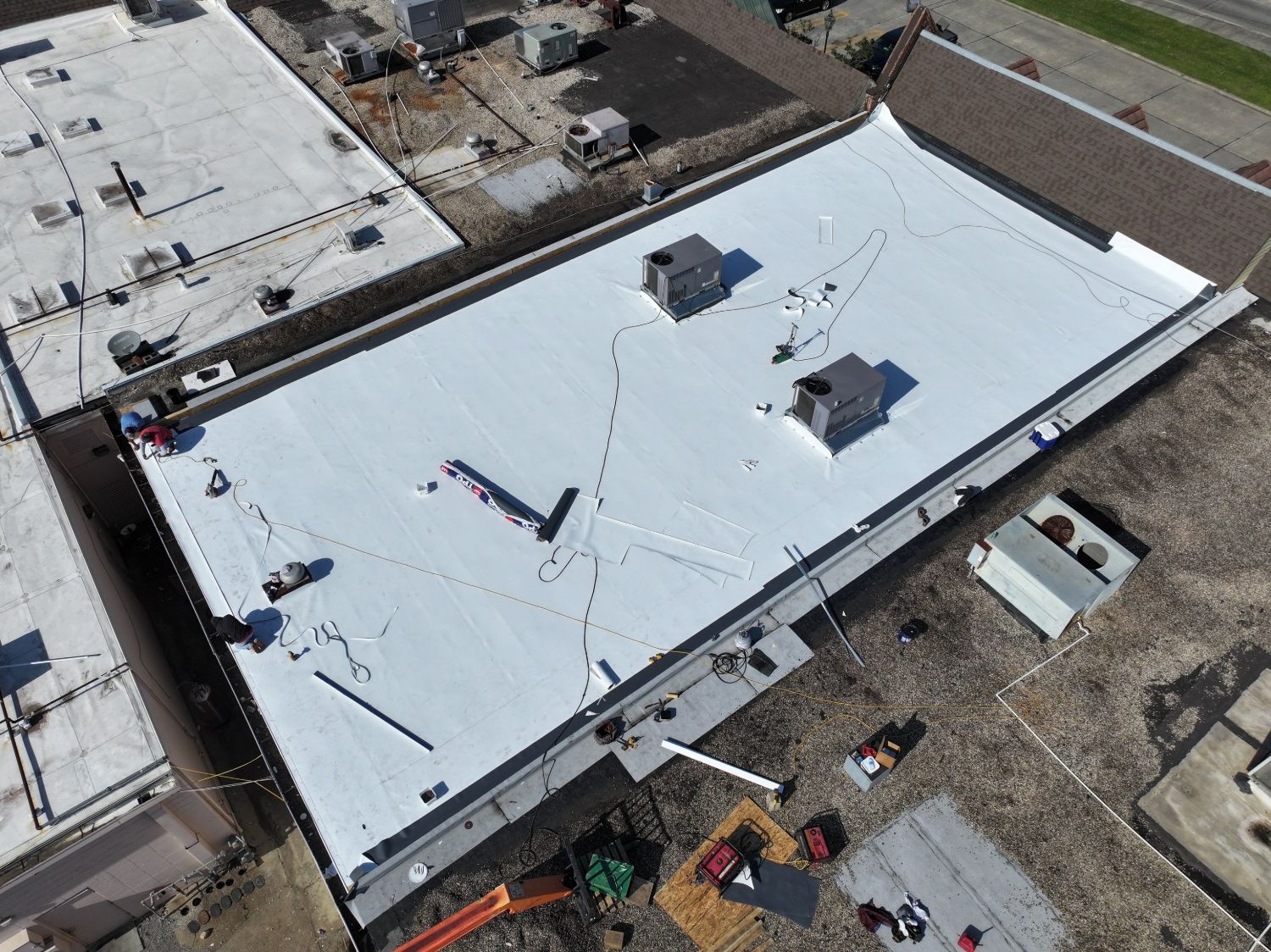 Commercial TPO membrane roof installation on a large low-slope building in Louisiana
