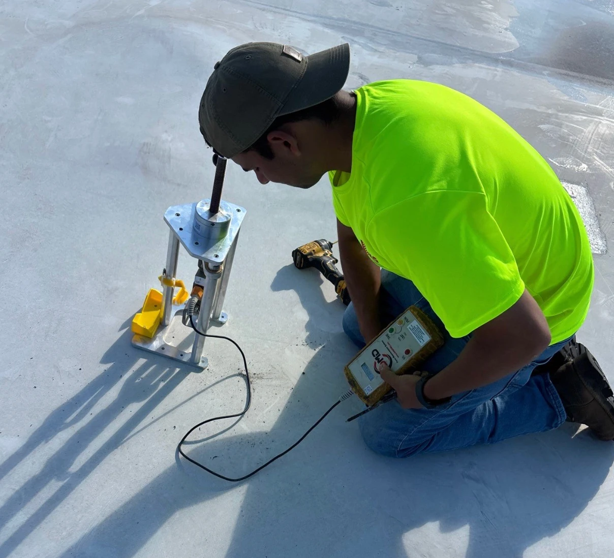 Brown's Roofing technician testing the existing membrane and insulation on a commercial roof in Monroe, Louisiana before a reroof proposal