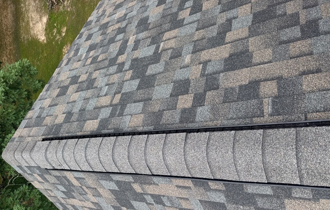 Close-up of a clean Owens Corning ProEdge hip and ridge line over a ridge vent on a Sheridan, Arkansas roof
