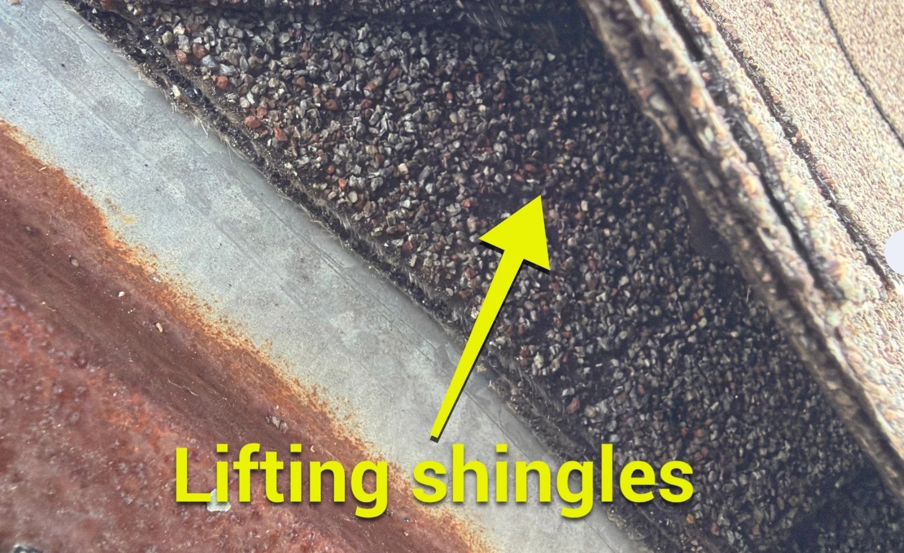 Lifted shingles at a roof edge, the kind of damage to look for before a hurricane