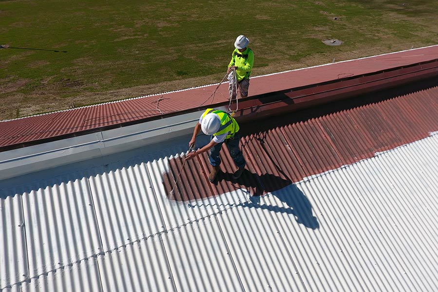 Applying a roof coating. 