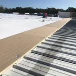 Flat metal retrofit roof installation
