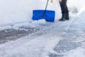 Ice rake removing snow and ice from flat roof